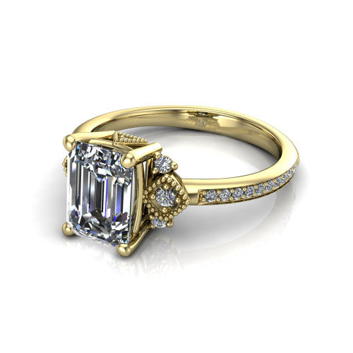 Presley emerald-cut three stone engagement ring in 18K Yellow Gold, three-quarter perspective showing the emerald-cut center diamond, diamond side clusters, and pavé band
