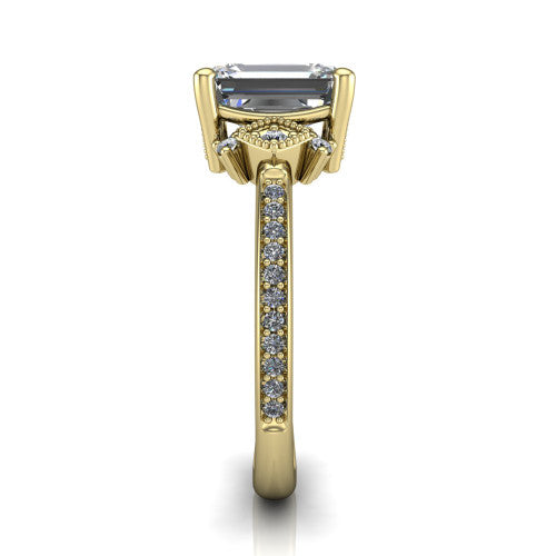 Presley emerald-cut three stone engagement ring in 18K Yellow Gold, side profile showing the diamond side clusters and pavé band
