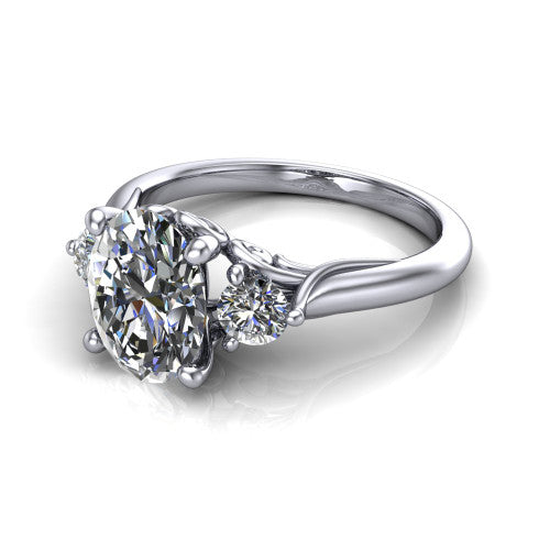 Harley oval three stone engagement ring in 18K White Gold, three-quarter perspective showing the brilliant oval center diamond flanked by two round side diamonds on tapered cathedral shoulders