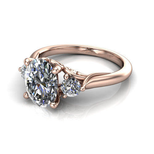 Harley oval three stone engagement ring in 14K Rose Gold, three-quarter perspective showing the brilliant oval center diamond flanked by two round side diamonds on tapered cathedral shoulders