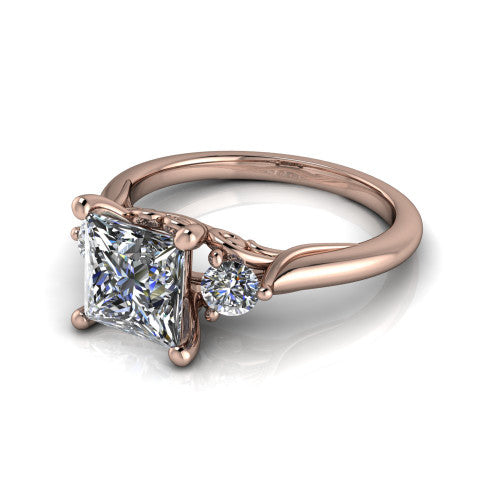 Harley princess three stone engagement ring in 18K Rose Gold, three-quarter perspective showing the brilliant princess-cut center diamond flanked by two round side diamonds on tapered cathedral shoulders