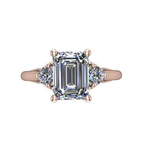 Harley emerald three stone engagement ring in 14K Rose Gold, top-down view showing the step-cut emerald center diamond with two matched round side diamonds