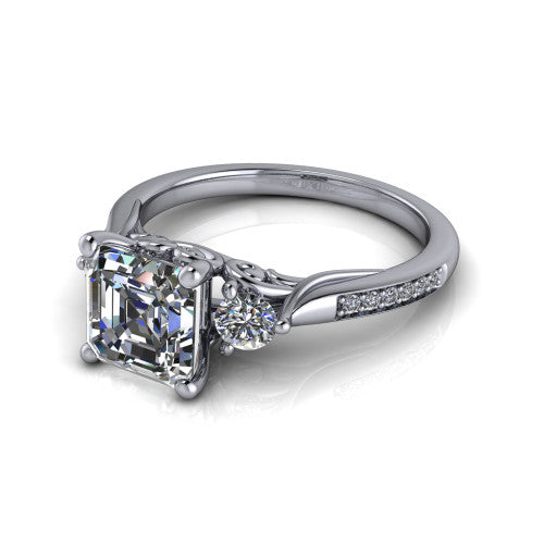 Celine square emerald three stone engagement ring in 18K White Gold, three-quarter perspective showing the step-cut square emerald center diamond flanked by two round side diamonds on a pave band