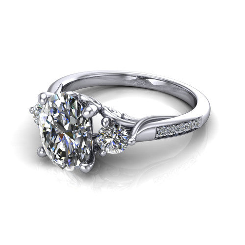 Celine oval three stone engagement ring in Platinum, three-quarter perspective showing the brilliant oval center diamond flanked by two round side diamonds on a pave band