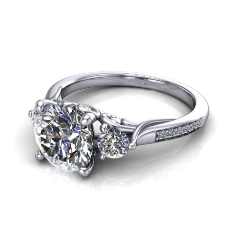 Celine round three stone engagement ring in 18K White Gold, three-quarter perspective showing the brilliant round center diamond flanked by two round side diamonds on a pave band