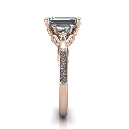 Celine emerald three stone engagement ring in 14K Rose Gold, side profile showing the filigree gallery and pave diamond band along the shoulders