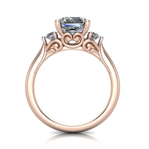 Celine square emerald three stone engagement ring in 14K Rose Gold, through-finger front profile showing the three-stone head and filigree scrollwork under-gallery