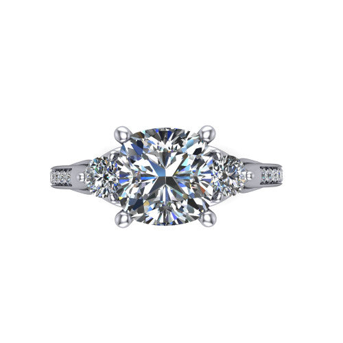 Celine cushion three stone engagement ring in 18K White Gold, three-quarter perspective showing the brilliant cushion-cut center diamond flanked by two round side diamonds on a pave band