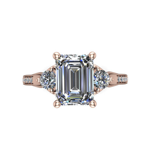 Celine emerald three stone engagement ring in 18K Rose Gold, top-down view showing the step-cut emerald center diamond with two matched round side diamonds