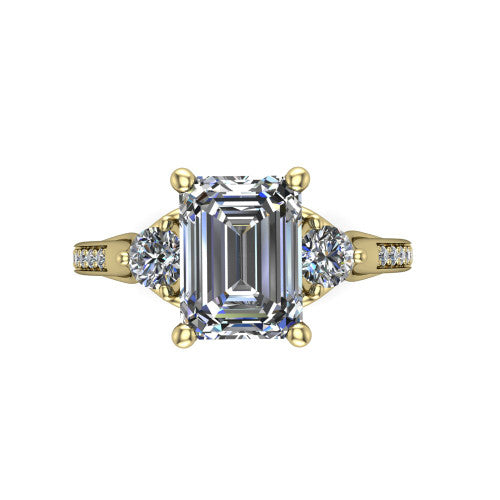 Celine emerald three stone engagement ring in 14K Yellow Gold, top-down view showing the step-cut emerald center diamond with two matched round side diamonds