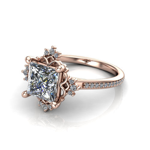Jayla princess solitaire engagement ring in 18K Rose Gold, three-quarter perspective showing the brilliant princess-cut center diamond inside an ornate floral openwork frame on a pave band