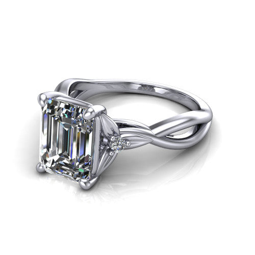 Catalina emerald three stone engagement ring in 18K White Gold, three-quarter perspective showing the step-cut emerald center diamond flanked by two round side accent diamonds on a twisted infinity shank