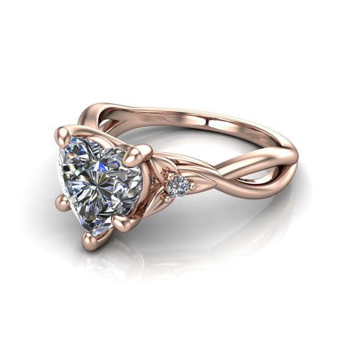 Catalina heart three stone engagement ring in 14K Rose Gold, three-quarter perspective showing the brilliant heart-shaped center diamond flanked by two round side accent diamonds on a twisted infinity shank