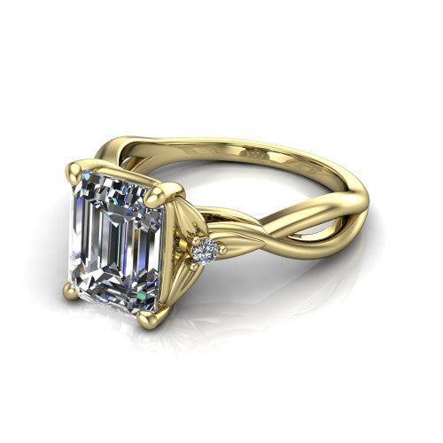 Catalina emerald three stone engagement ring in 18K Yellow Gold, three-quarter perspective showing the step-cut emerald center diamond flanked by two round side accent diamonds on a twisted infinity shank