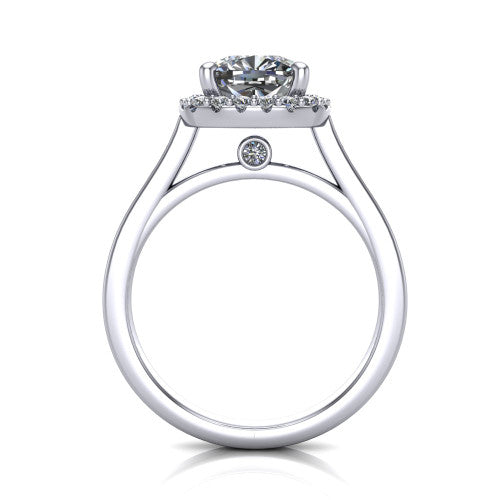 Brooke cushion halo engagement ring in Platinum, through-finger front profile showing the cathedral gallery with a bezel-set peekaboo diamond beneath the center