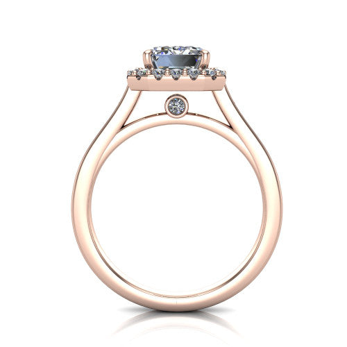 Brooke emerald halo engagement ring in 18K Rose Gold, through-finger front profile showing the cathedral gallery with a bezel-set peekaboo diamond beneath the center