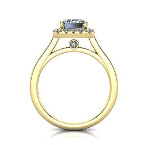 Brooke emerald halo engagement ring in 18K Yellow Gold, through-finger front profile showing the cathedral gallery with a bezel-set peekaboo diamond beneath the center