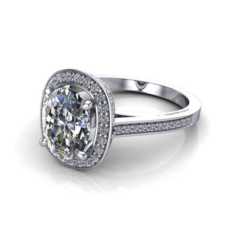 Giselle oval halo engagement ring in Platinum, three-quarter perspective showing the milgrain haloed center above a pav&eacute; band with a peekaboo gallery accent