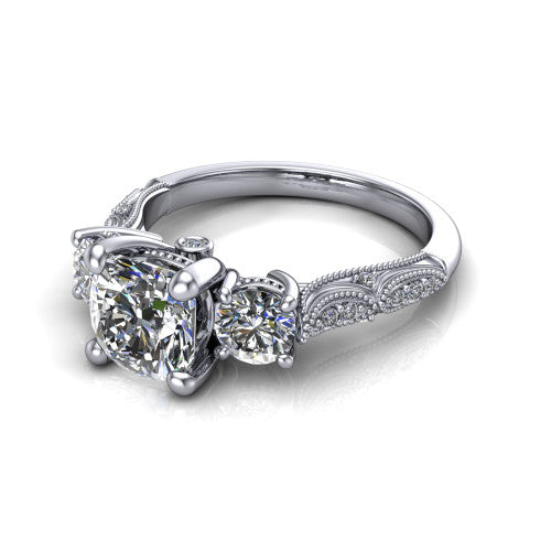 Rosemary cushion three stone engagement ring in 14K White Gold, three-quarter perspective showing the three-stone row with milgrain shoulders and filigree detailing above a pav&eacute; band