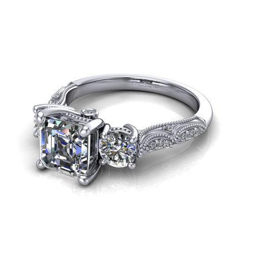 Rosemary square emerald three stone engagement ring in 14K White Gold, three-quarter perspective showing the three-stone row with milgrain shoulders and filigree detailing above a pav&eacute; band