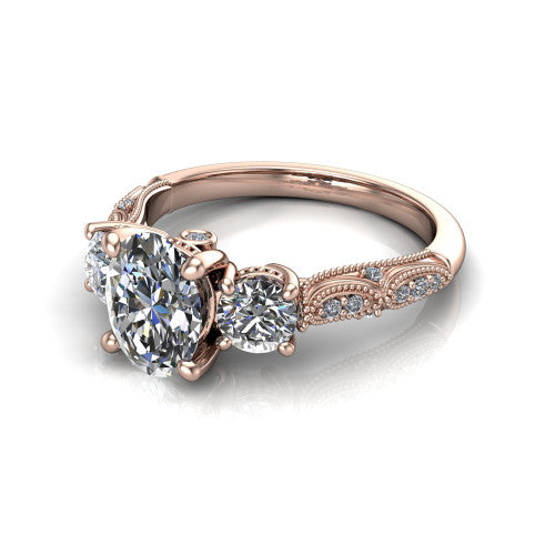 Rosemary oval three stone engagement ring in 18K Rose Gold, three-quarter perspective showing the three-stone row with milgrain shoulders and filigree detailing above a pav&eacute; band