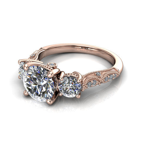 Rosemary round three stone engagement ring in 18K Rose Gold, three-quarter perspective showing the three-stone row with milgrain shoulders and filigree detailing above a pav&eacute; band