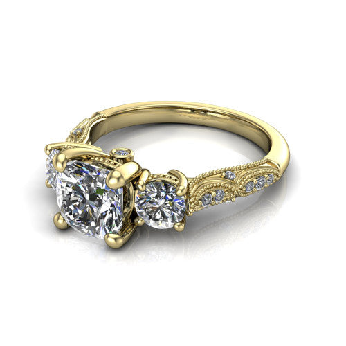 Rosemary cushion three stone engagement ring in 14K Yellow Gold, three-quarter perspective showing the three-stone row with milgrain shoulders and filigree detailing above a pav&eacute; band