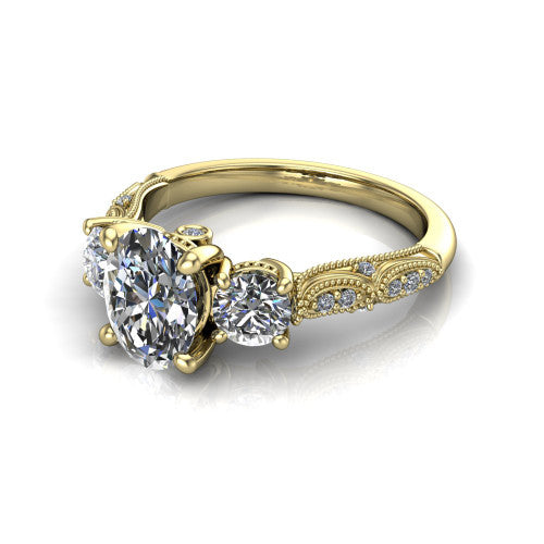 Rosemary oval three stone engagement ring in 18K Yellow Gold, three-quarter perspective showing the three-stone row with milgrain shoulders and filigree detailing above a pav&eacute; band