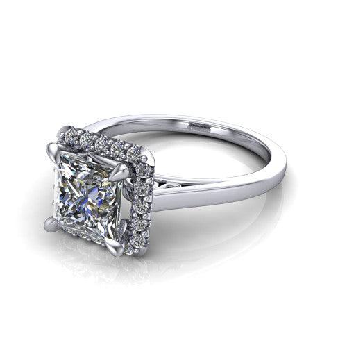 Esmeralda princess halo engagement ring in 18K White Gold, three-quarter perspective showing the haloed center above a plain band with a filigree gallery