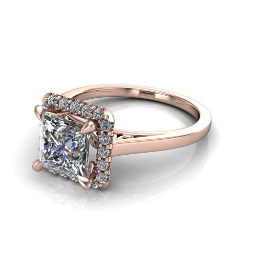 Esmeralda princess halo engagement ring in 18K Rose Gold, three-quarter perspective showing the haloed center above a plain band with a filigree gallery