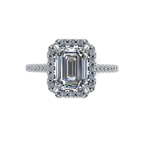 Birdie emerald halo engagement ring in 18K White Gold, top-down view showing the center framed by a emerald pav&eacute; halo with compass prongs