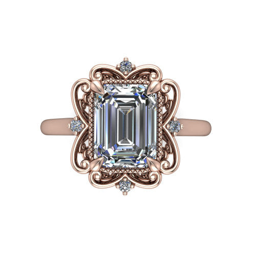 Gracelyn emerald halo engagement ring in 18K Rose Gold, top-down view showing the center diamond within an open carved filigree halo with fleur-de-lis corners