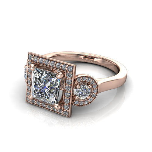 Colette princess-cut three-stone halo engagement ring in 14K Rose Gold, three-quarter perspective showing the princess-cut center diamond and two round side stones, each in a pave halo, across the band