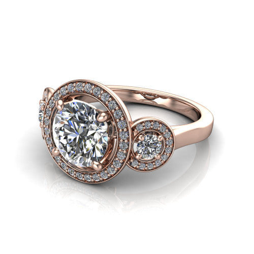 Colette round three-stone halo engagement ring in 18K Rose Gold, three-quarter perspective showing the round center diamond and two round side stones, each in a pave halo, across the band