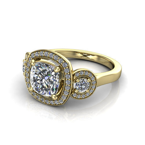 Colette cushion three-stone halo engagement ring in 18K Yellow Gold, three-quarter perspective showing the cushion center diamond and two round side stones, each in a pave halo, across the band