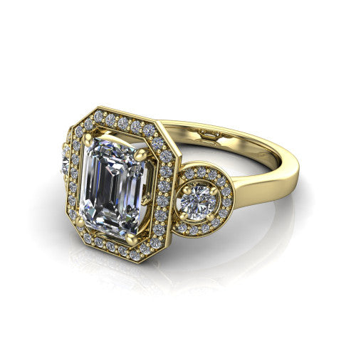 Colette emerald-cut three-stone halo engagement ring in 14K Yellow Gold, three-quarter perspective showing the emerald-cut center diamond and two round side stones, each in a pave halo, across the band