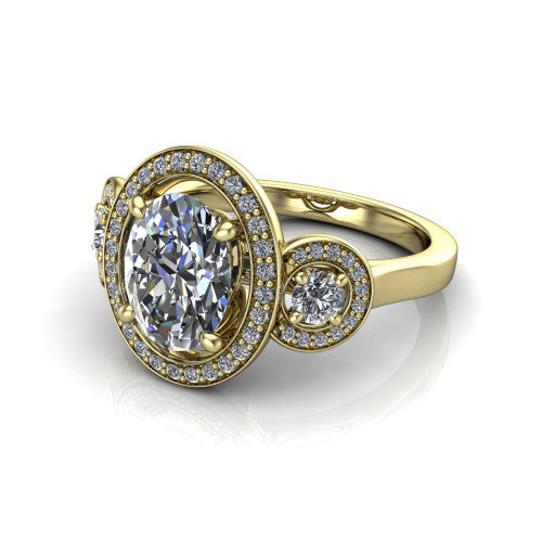Colette oval three-stone halo engagement ring in 18K Yellow Gold, three-quarter perspective showing the oval center diamond and two round side stones, each in a pave halo, across the band