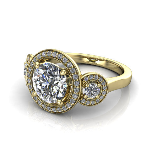 Colette round three-stone halo engagement ring in 18K Yellow Gold, three-quarter perspective showing the round center diamond and two round side stones, each in a pave halo, across the band