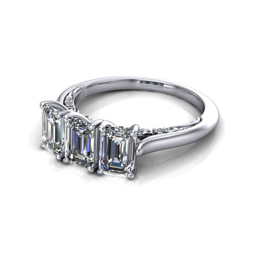 Kora emerald-cut three-stone engagement ring in 14K White Gold, three-quarter perspective showing the three matched emerald-cut diamonds, pave-set band, and vintage scrollwork gallery