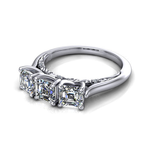 Kora square emerald-cut three-stone engagement ring in Platinum, three-quarter perspective showing the three matched square emerald-cut diamonds, pave-set band, and vintage scrollwork gallery