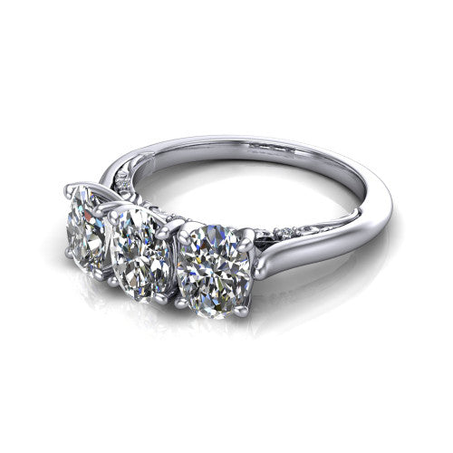 Kora oval three-stone engagement ring in 18K White Gold, three-quarter perspective showing the three matched oval diamonds, pave-set band, and vintage scrollwork gallery