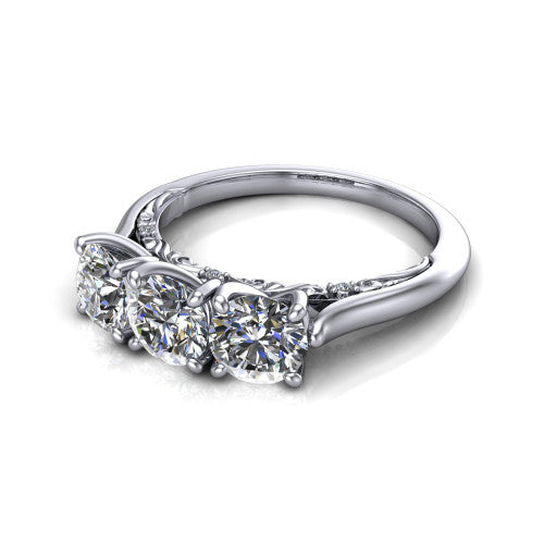 Kora round three-stone engagement ring in Platinum, three-quarter perspective showing the three matched round diamonds, pave-set band, and vintage scrollwork gallery