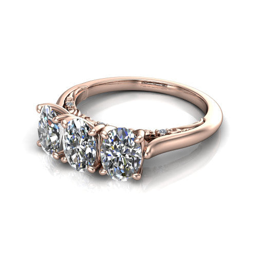 Kora oval three-stone engagement ring in 18K Rose Gold, three-quarter perspective showing the three matched oval diamonds, pave-set band, and vintage scrollwork gallery