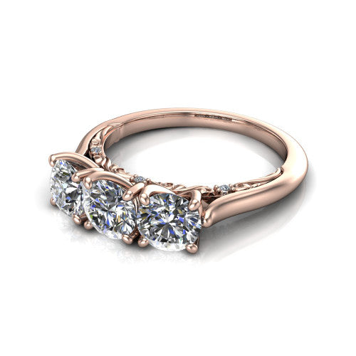Kora round three-stone engagement ring in 18K Rose Gold, three-quarter perspective showing the three matched round diamonds, pave-set band, and vintage scrollwork gallery