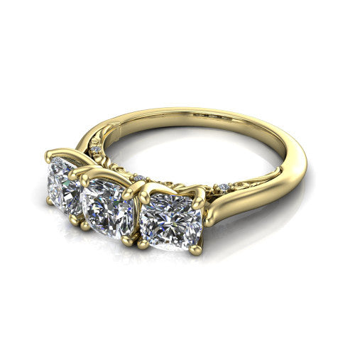 Kora cushion three-stone engagement ring in 14K Yellow Gold, three-quarter perspective showing the three matched cushion diamonds, pave-set band, and vintage scrollwork gallery