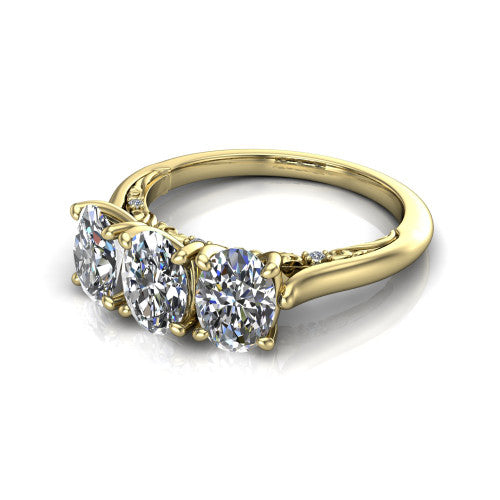 Kora oval three-stone engagement ring in 18K Yellow Gold, three-quarter perspective showing the three matched oval diamonds, pave-set band, and vintage scrollwork gallery