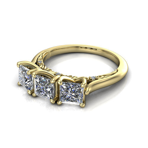 Kora princess-cut three-stone engagement ring in 14K Yellow Gold, three-quarter perspective showing the three matched princess-cut diamonds, pave-set band, and vintage scrollwork gallery
