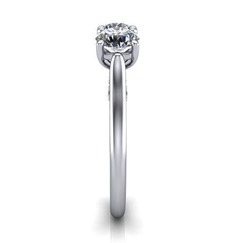 Kora round three-stone engagement ring in Platinum, side profile showing the pave-set band, scrollwork gallery, and high-polish profile