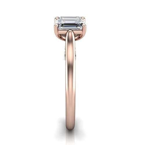 Kora emerald-cut three-stone engagement ring in 18K Rose Gold, side profile showing the pave-set band, scrollwork gallery, and high-polish profile