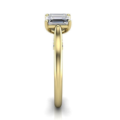 Kora emerald-cut three-stone engagement ring in 14K Yellow Gold, side profile showing the pave-set band, scrollwork gallery, and high-polish profile